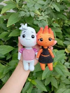 two small crocheted dolls are held in their hands