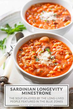 two white bowls filled with soup and garnished with parmesan cheese