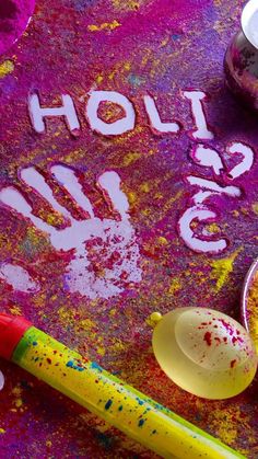 colorful chalk and paint with the words holi glo written on it