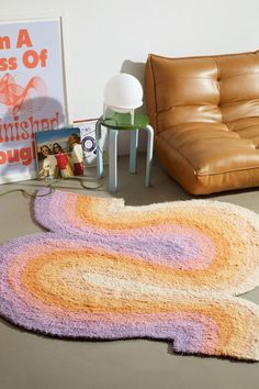 a living room with a couch and rugs on the floor