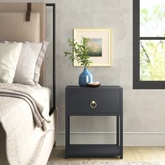 a bedroom scene with focus on the nightstand and bed