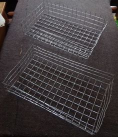 two metal baskets sitting on top of a table