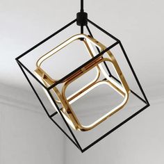 a suspended light fixture in the shape of a cube with two square sections on each side