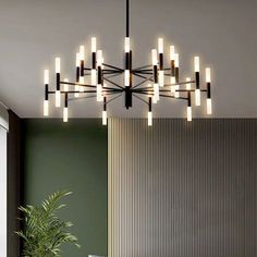 a modern chandelier hanging from the ceiling in a living room