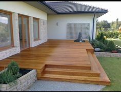 a wooden deck in front of a house