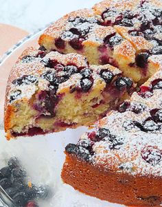 a cake with blueberries and powdered sugar on top