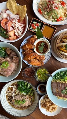 a table topped with plates and bowls filled with different types of food on top of it