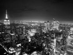 black and white photograph of new york city at night from the top of the empire building