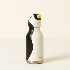 a black and white penguin water bottle on a white surface with the lid down, sitting upright