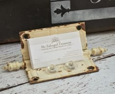 an old wooden box with two small silver studs