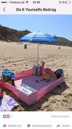 an umbrella and some bags on the beach