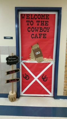 a door decorated with an image of a cow and the words welcome to the cowboy cafe