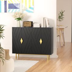 a black cabinet with gold accents in a living room