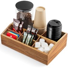 a wooden container filled with lots of food and coffee beans on top of a table