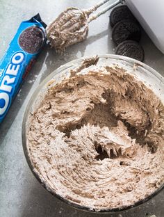 an oreo cookie dough in a glass bowl with a whisk next to it