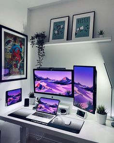 three computer monitors sitting on top of a white desk