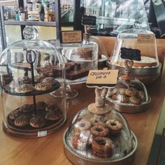 various types of donuts under glass on display