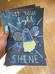 someone holding up a card that says let your name shine