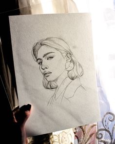 a drawing of a woman's face on paper