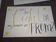 two signs that say, will you light my night at prom? and have stars on them