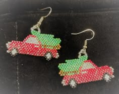 a pair of beaded earrings with red and green cars in the shape of christmas trees