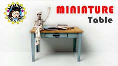 a miniature skeleton sitting on top of a table