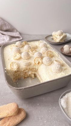 a cake in a pan on a table next to some cookies and other dessert items