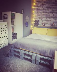 a bedroom with a bed made out of pallets and lights on the headboard