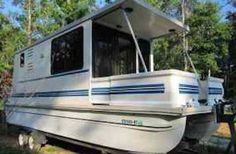 a house boat is parked in the grass