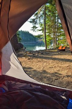 the inside of a tent with trees in the background