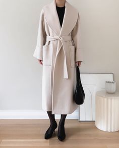 Refined merino wool and alpaca wrap overcoat featuring shawl collar silhouette and folded cuff detail. Handmade. - Oversize cut- Shawl collar- Tie waist- Front flap pockets- Back vent- Fully lined- Measurements: Length 47", Bust 44", Sleeve 30.5"- Outer: Merino Wool 80%, Alpaca 20% Lining: Polyester 100%- Dry clean- Imported Alpaca Coat, Sleeveless Trench, Wool Overcoat, Outerwear Outfit, Women Shawl, Cuff Detail, Cool Street Fashion, Cashmere Coat, Shawl Collar