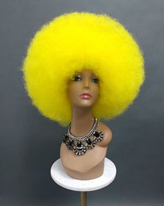 "A large size afro wig that packs plenty of volume and wow factor. Made with synthetic fibers. Color: Yellow Circumference: Default at 21\" with stretch cap (max 22\") Materials: Synthetic Wig Fibers All sales are final. Please read all store policies before purchasing." Afro Wig, Afro Wigs, Costume Wigs, Synthetic Wig, Remy Hair, Styling Tools, 100 Human Hair, Synthetic Wigs, Human Hair Wigs