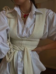 a woman wearing a white shirt and tie