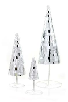 three mirrored christmas trees sitting on top of each other in front of a white background