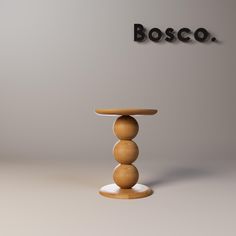 a wooden table sitting on top of a white floor next to a sign that says bosco