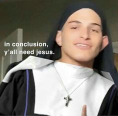 a young man wearing a priest's robe and giving the peace sign