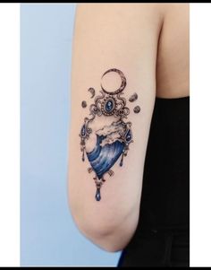 a woman's arm with a tattoo on it and an image of the moon