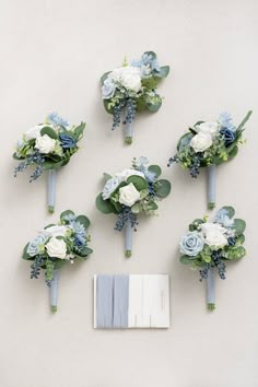 the bridal bouquets are arranged on the wall next to each other, including blue and white flowers