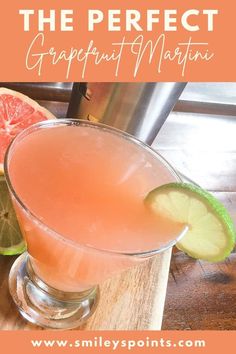 a pink grapefruit martini is garnished with lime