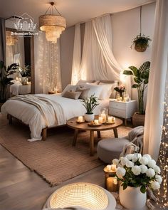 a bedroom decorated in white with candles and flowers