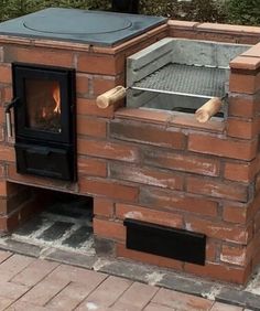 an outdoor brick pizza oven built into the side of a building