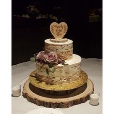 a three tiered wedding cake sitting on top of a table