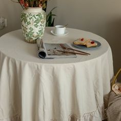 a white table topped with a vase filled with flowers