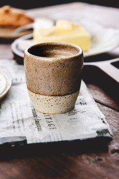 a coffee cup sitting on top of a napkin