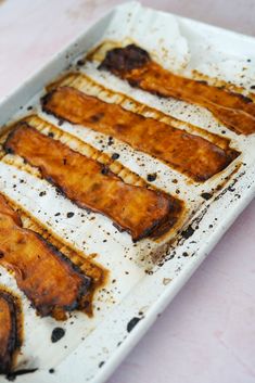 some food is sitting on a white tray and ready to be cooked in the oven