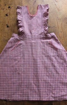 FRENCH VINTAGE 50's, lovely pinafore dress / apron dress, pink and blue checkered cotton fabric, red trim edges, wide open sleeves, two patch pockets, buttoned down the waist ( glass buttons ). Estimated size 9 years : Length 32,3" New old stock ( washed once ) In case of multiple purchases, if you want an accurate shipping estimation, please contact me ; I do always refund overcharged shipping from 1 Euro overpaid ! Thank you for your visit Retro Cotton School Dress, Vintage Cotton Plaid Dress, Vintage Sleeveless Plaid Cotton Dress, Plaid Cotton Vintage Dress, Pink Cotton School Dress, Pink Cotton Dress For School, Vintage Cotton Gingham Plaid Dress, Cotton Plaid Ruffled Dress For Picnic, Vintage Gingham Plaid Cotton Dress