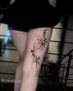 a woman's leg with tattoos on it