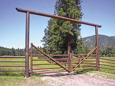 an open gate in the middle of a field