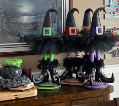 several witches hats are on display in front of a painting and other decorating items