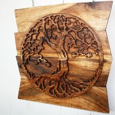 a wooden wall hanging with a tree on it